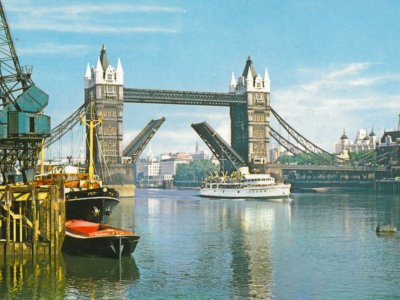An old postcard of Tower Bridge lifting for a large ship