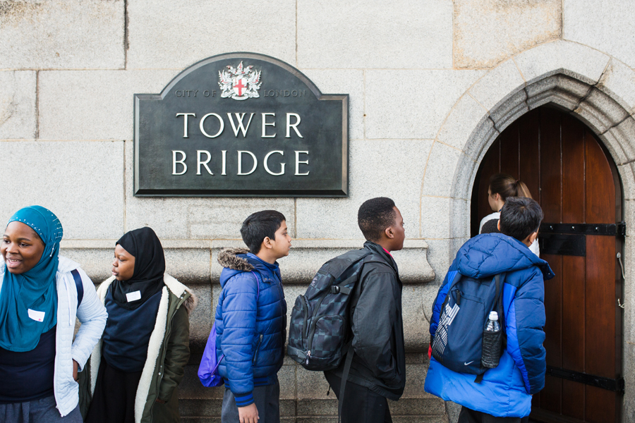 A school group lines up outside Tower Bridge