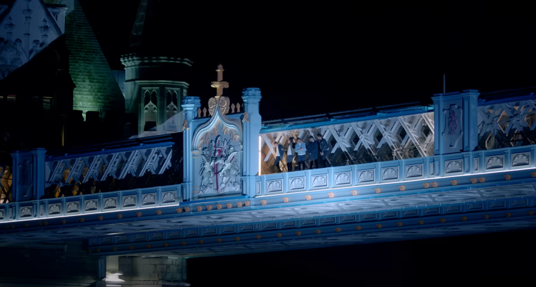 One Direction members stand on the Walkways at Tower Bridge