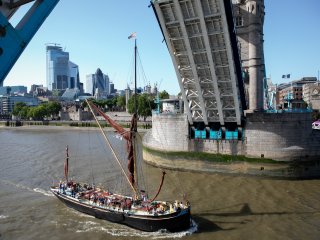 boat sailing through Tower Bridge