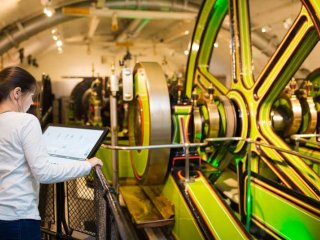 Girl looking at the historic Engines that once powered Tower Bridge