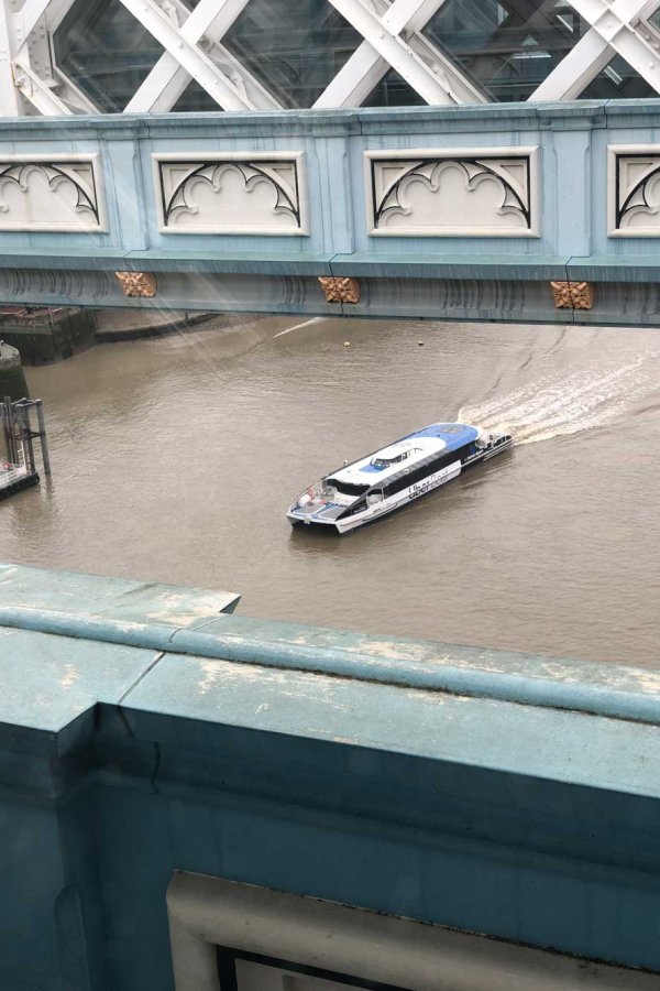 Boat passing under Tower Bridge