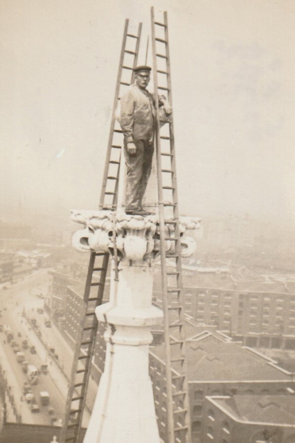 Arthur Cross stands at the top of Tower Bridge Tower during construction