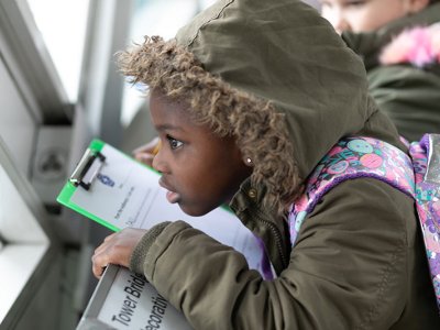 pupil looks out of Tower Bridge's high level walkways window