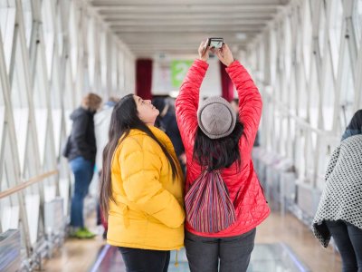 People taking a selfie on the Glass Floor inside Tower Bridge