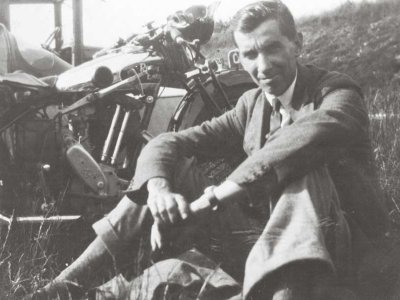 Edward Forrest sitting next to his motorbike