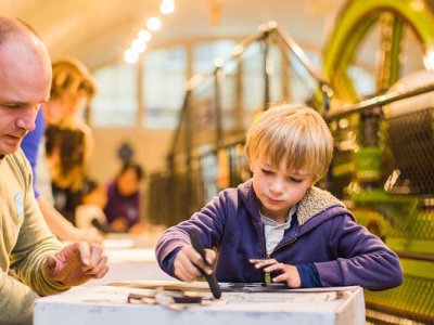 Boy drawing with charcoal inside Engine Rooms