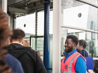 A Welcome Host greets visitors at Tower Bridge