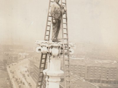 Arthur Cross stands at the top of Tower Bridge Tower during construction