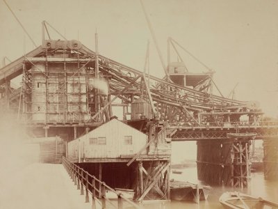 Sepia photograph of Tower Bridge under construction