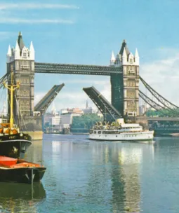 An old postcard of Tower Bridge lifting for a large ship
