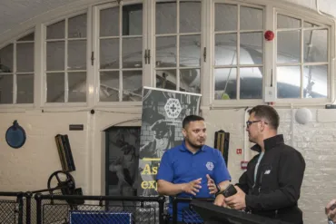 A member of the technical team talking to a visitor at the Engine Rooms of Tower Bridge.
