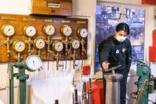 A guest on the Behind-the-Scenes tour at the Tower Bridge Control Cabin
