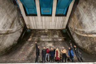 A group of visitors and an expert guide in the Bascule Chambers of Tower Bridge