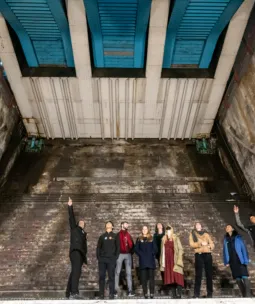 A group of visitors and an expert guide in the Bascule Chambers of Tower Bridge