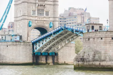 A close up image of Tower Bridge showing the bascules raising