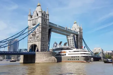 A large ship passing through Tower Bridge durin a Bridge Lift.