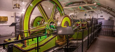 Tower Bridge's Engine Rooms interior - a large green steam engine wheel.