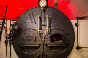 A black coal-fired boiler in the Engine Rooms of Tower Bridge.