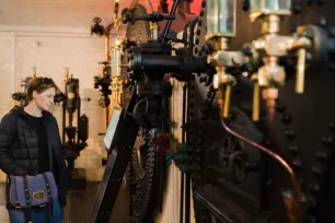 A visitor looking at the coal-fired boiler in the Engine Rooms at Tower Bridge.