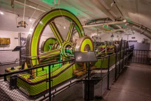 Tower Bridge's Engine Rooms interior - a large green steam engine wheel.