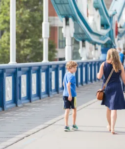 A family with two children walking across Tower Bridge.