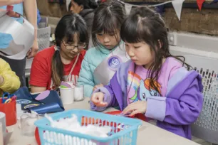 Three children making crafts together