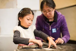 A children and her mother participating in an activity at Tower Bridge