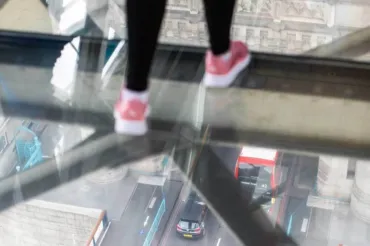 Visitor walking on the Glass Floors at Tower Bridge.
