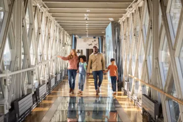 A family waling across the walkways at Tower Bridge