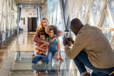 A man taking photos of his family on the High-level Walkways on his phone