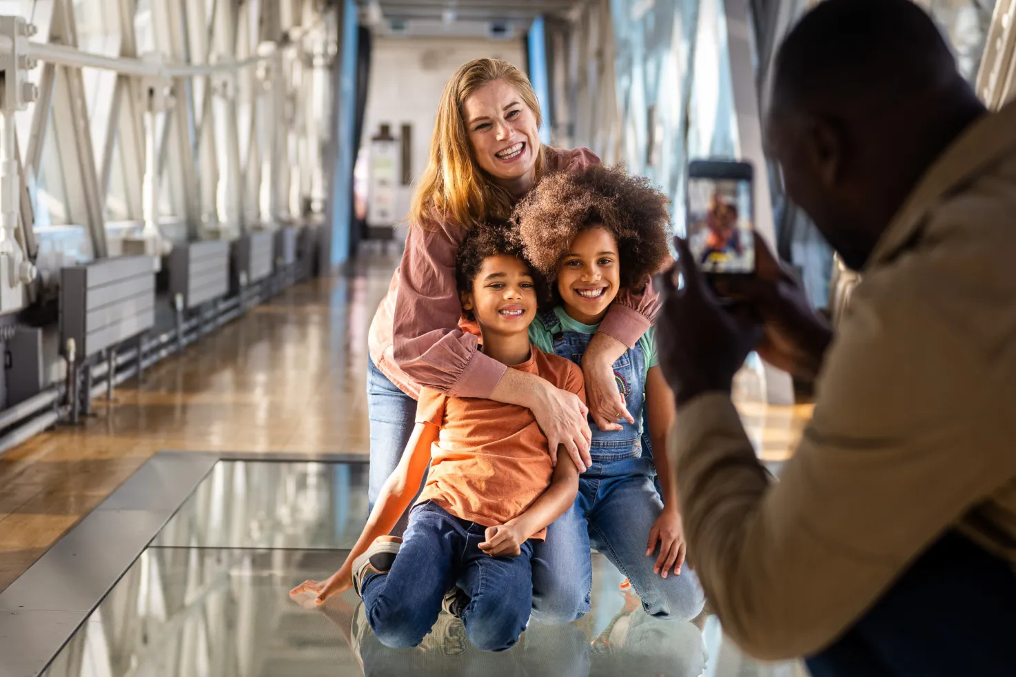 Family taking photos on the Glass Floors at Tower Bridge