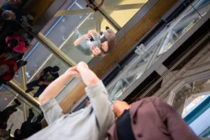 A couple taking photos on the Glass Floors at Tower Bridge.