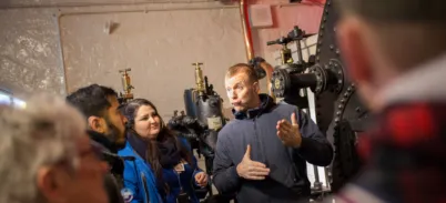 A British Sign Language Interpreter and Guide at the Engine Rooms with guests