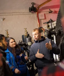 A British Sign Language Interpreter and Guide at the Engine Rooms with guests