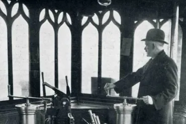A black and white photo of a man operating the Bridge Lift