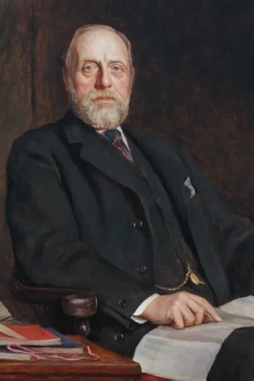 A portrait of a man in a black suit, with white hair and moustache