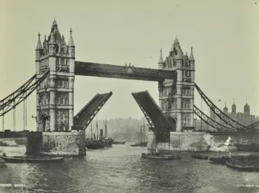 A black and white photo of Tower Bridge lifting