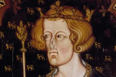 A historical portrait thought to be of Edward I, featuring a regal figure with shoulder-length wavy hair, wearing a golden crown adorned with leaves and jewels. The figure is dressed in royal attire with intricate patterns and holds a scepter topped with a decorative leaf design. The background is dark and decorated with repeated lion motifs.