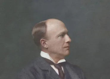Vintage portrait of Engineer George Edward Wilson Cruttwell wearing a dark suit jacket, white collared shirt, and a dark tie, set against a plain dark background. The image has a classic, formal style typical of early 20th-century Victorian photography.