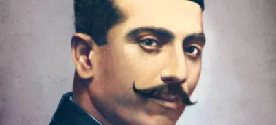 A studio portrait of an Indian man, smartly dressed