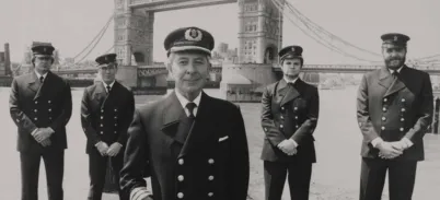 5 men standing in front of Tower Bridge