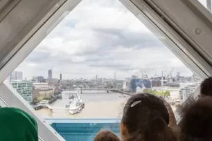 Children looking out of the window on the Walkways at Tower Bridge