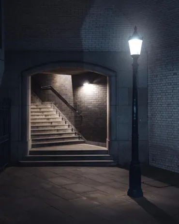 A set of stairs at Tower Bridge with a lamp post on the left