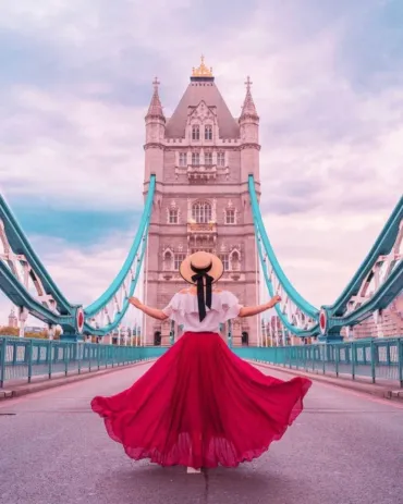 A lady in red dress in front of Tower Bridge