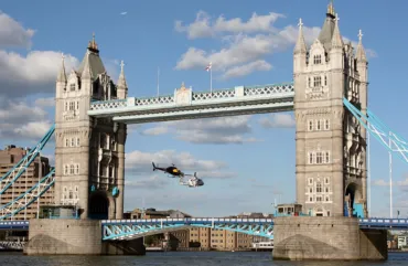 Two helicopters fly through Tower Bridge