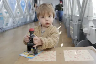 A young child collecting stamps during the Tower Bridge Cat Trail