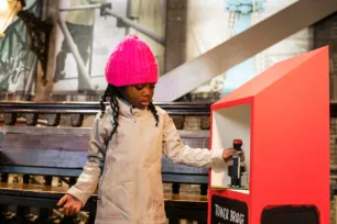 A young children collecting stamps for the Tower Bridge Cat Trail