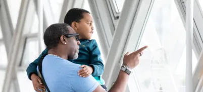 A family looking at the views on the Walkways at Tower Bridge.
