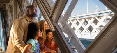 A family admiring the views from the Walkways at Tower Bridge